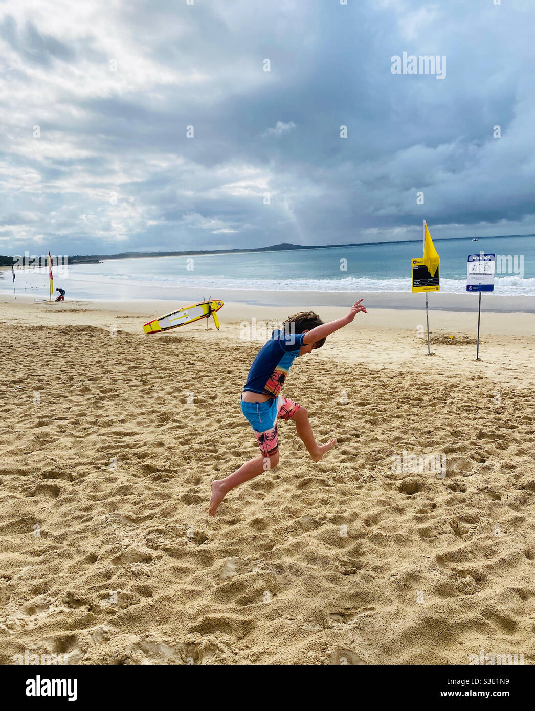 Boy jumping at beach Stock Photo