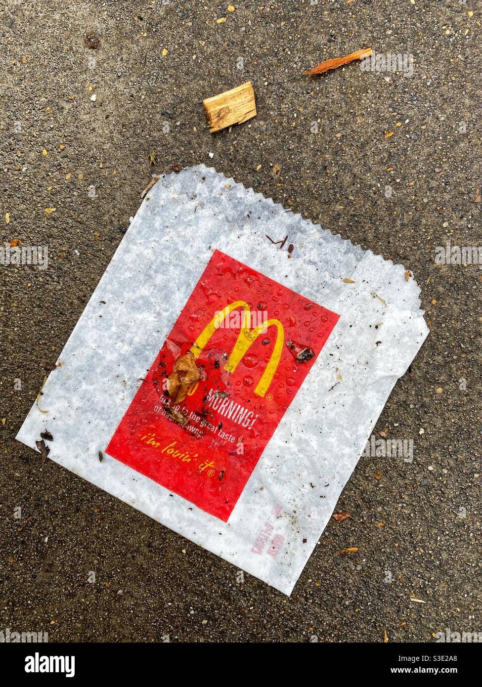 A McDonald's bag littered in the street Stock Photo