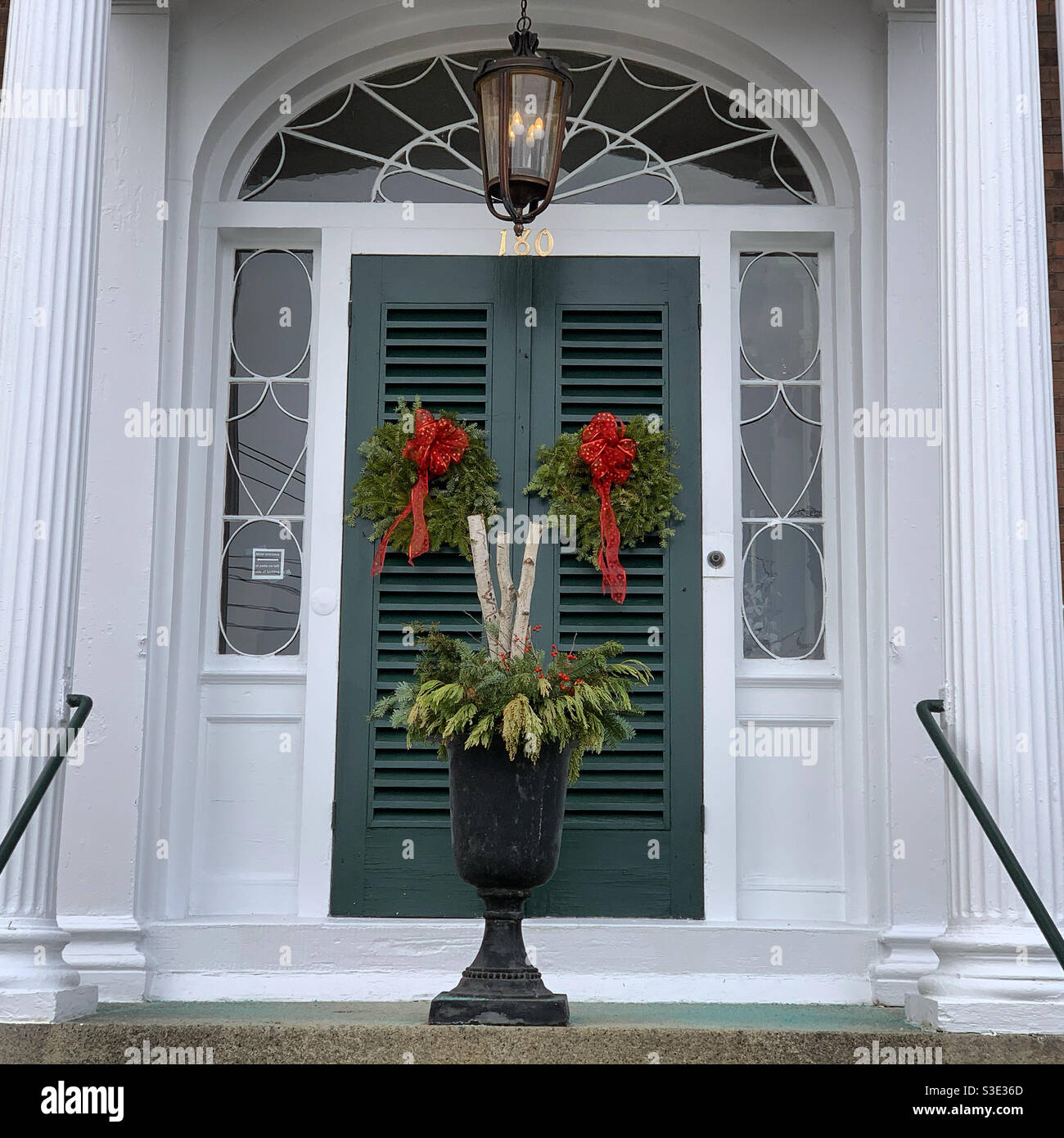 Holiday wreaths on the front doors of a building in Salem, Massachusetts, United States - Smartphone Captured Stock Image