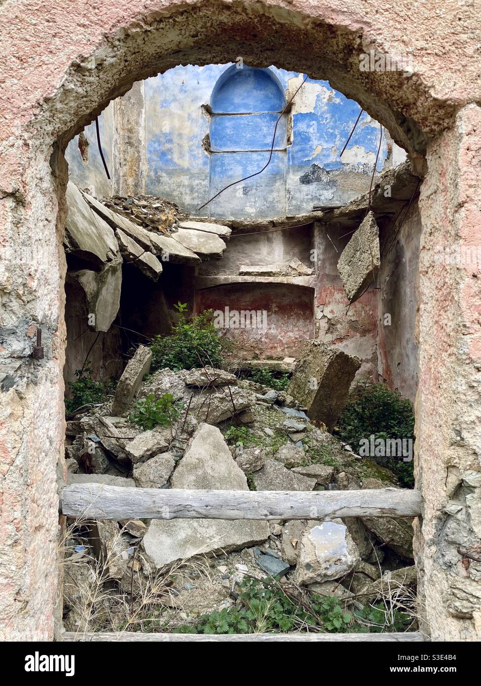 The ruins of an old building or house, its space  taken back by wild plants and vegetation, in the ghost town of Gairo vecchio, an abandoned place in the province of Ogliastra, Sardinia. Stock Photo