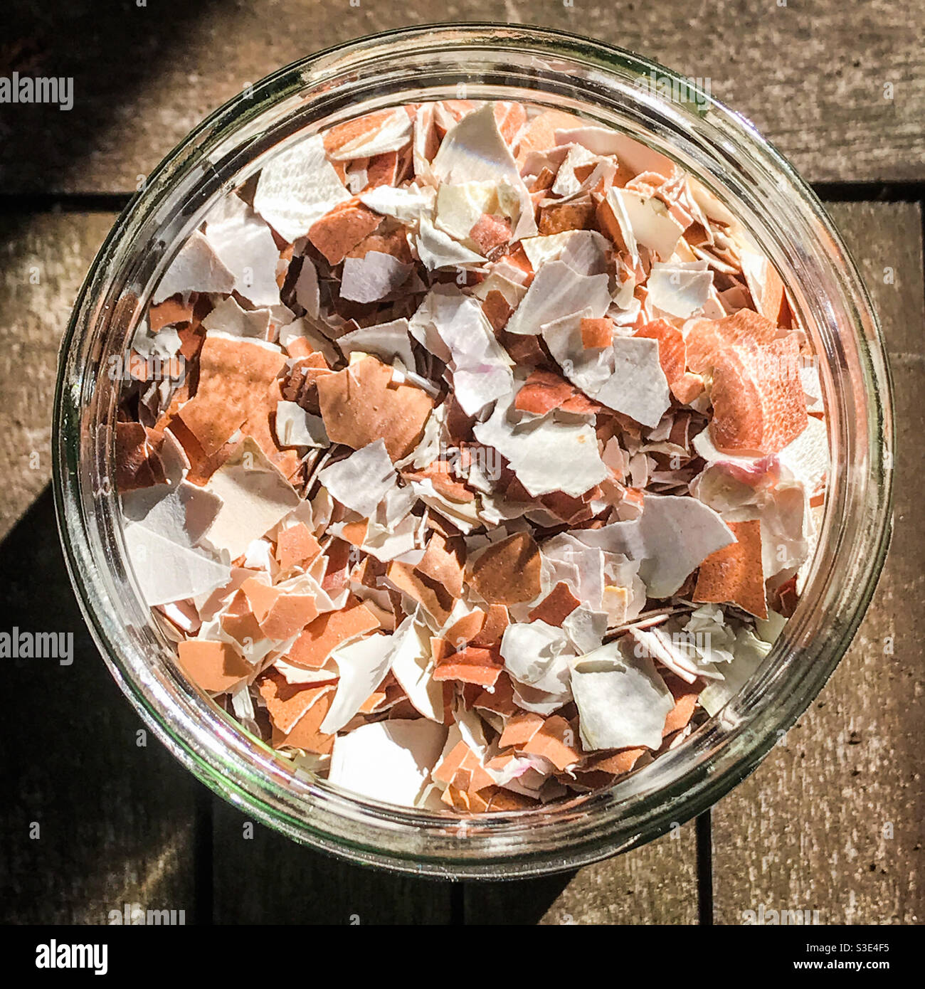 Crushed eggshells in a glass jar for garden plants fertiliser - Smartphone Captured Stock Image