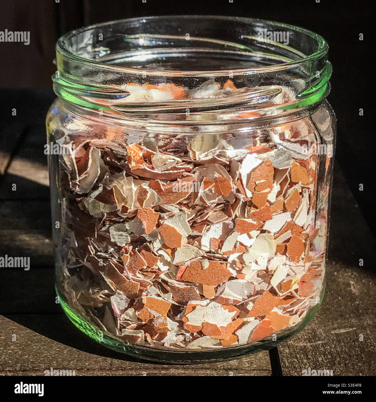 Crushed eggshells in a glass jar for garden plants fertiliser Stock Photo