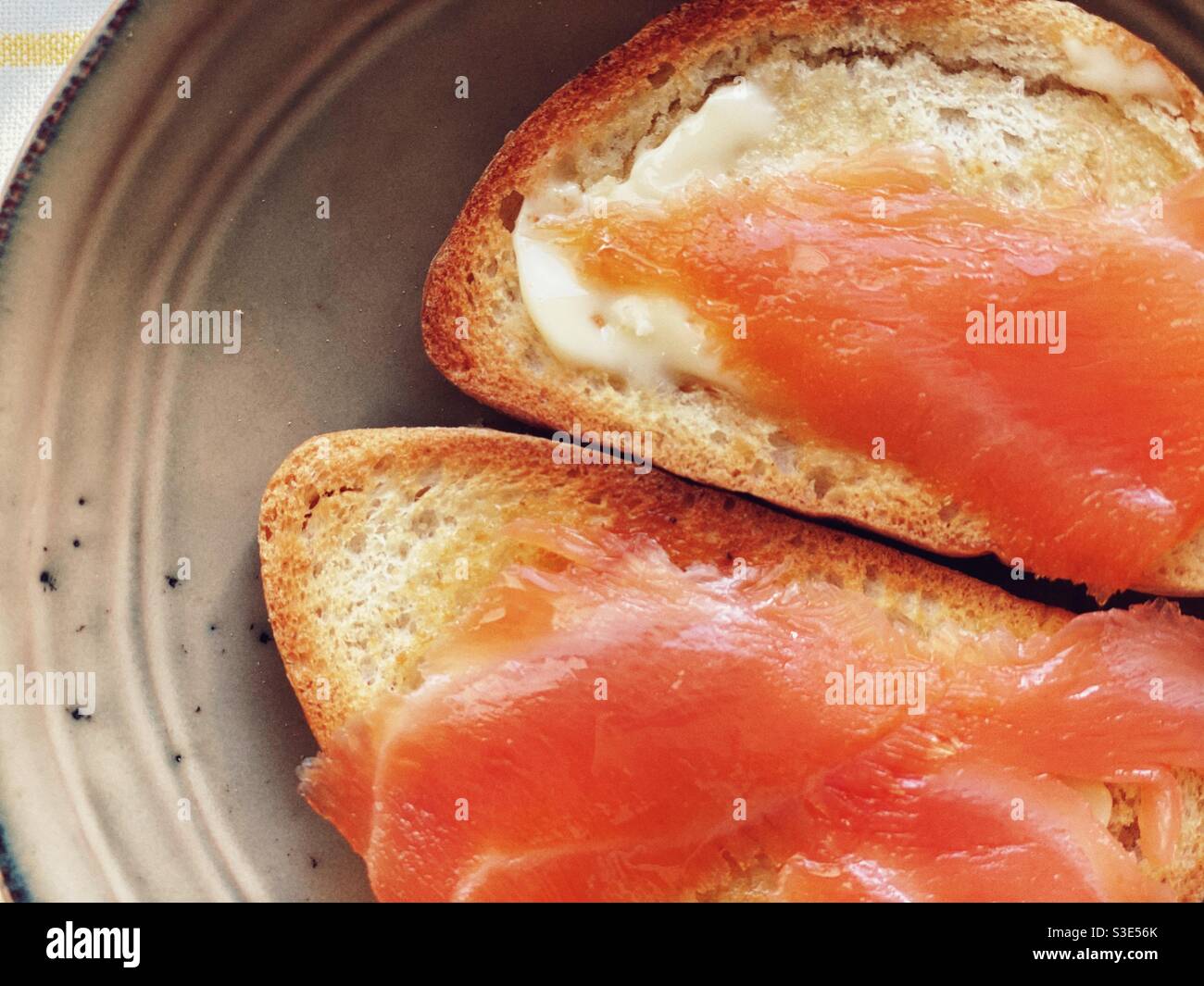 Tow golden kamut bread toast with salmon and butter Stock Photo