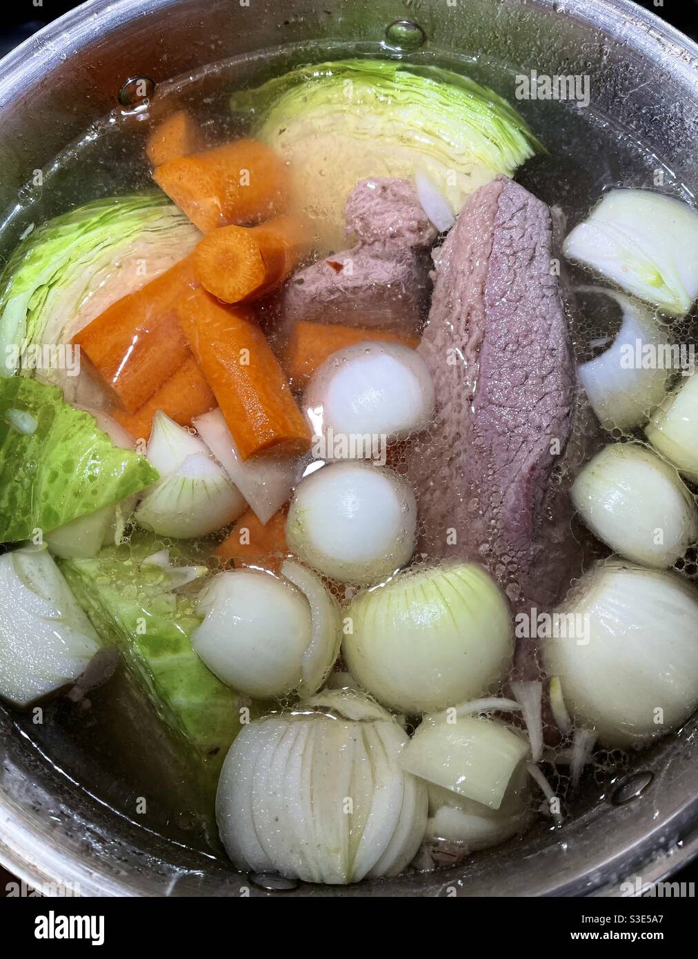 Traditional Irish boiled dinner with corned beef, carrots, potatoes and onions. Stock Photo