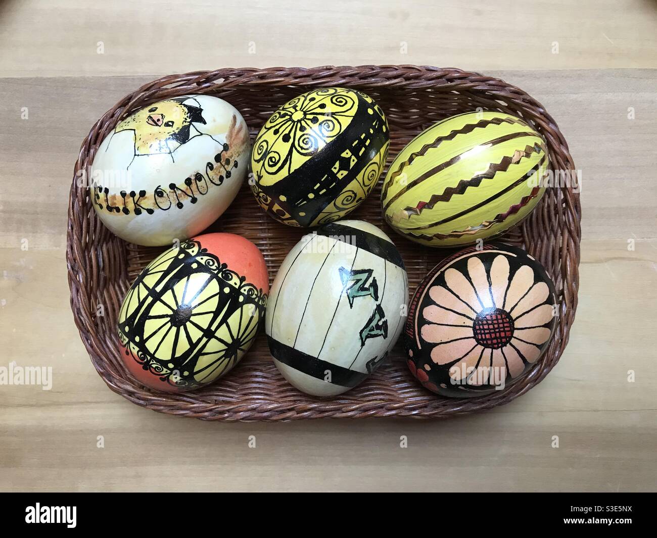 Wicker Basket with Painted Easter Eggs Stock Photo