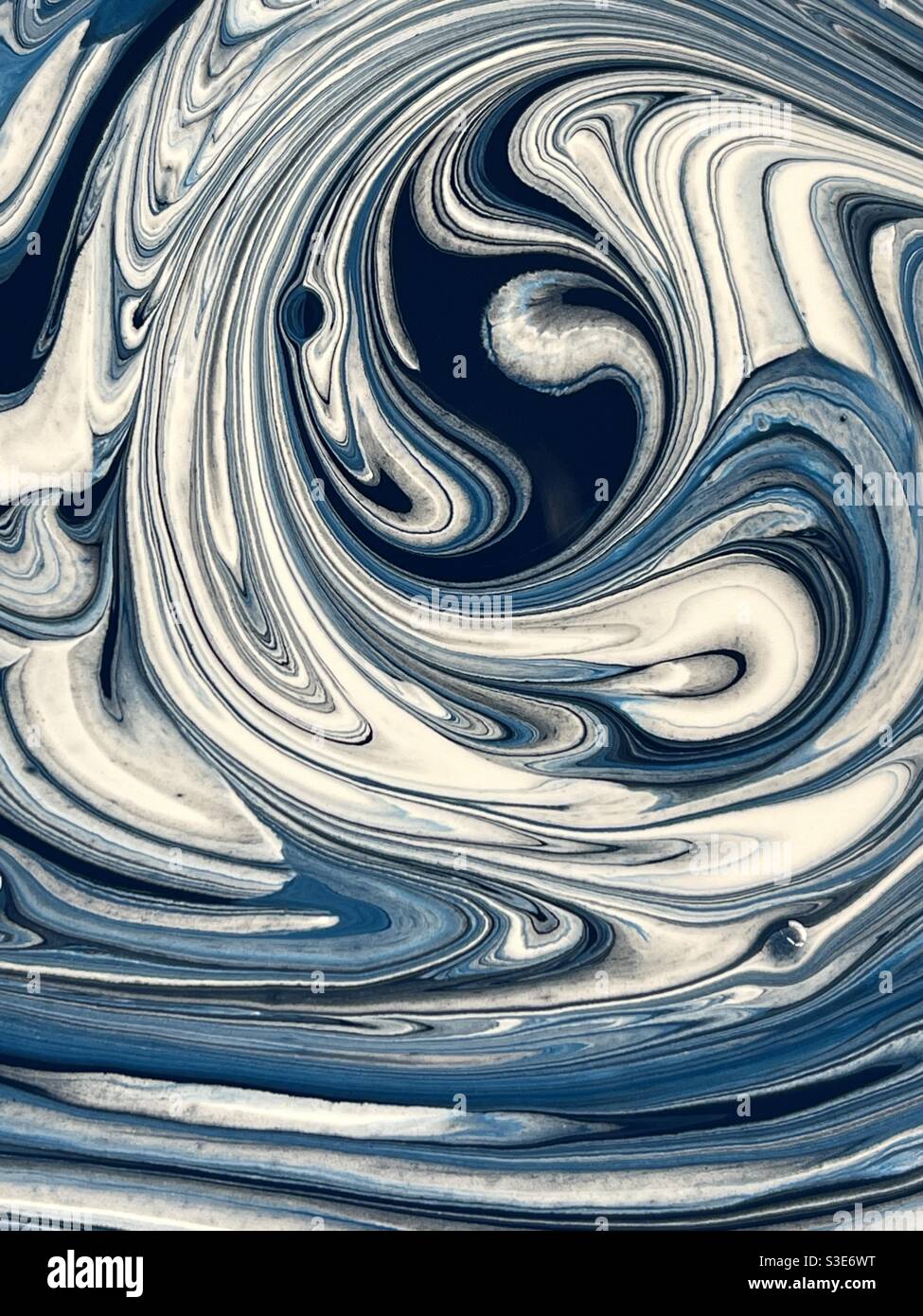 Magic swirls of blue and white paints Stock Photo