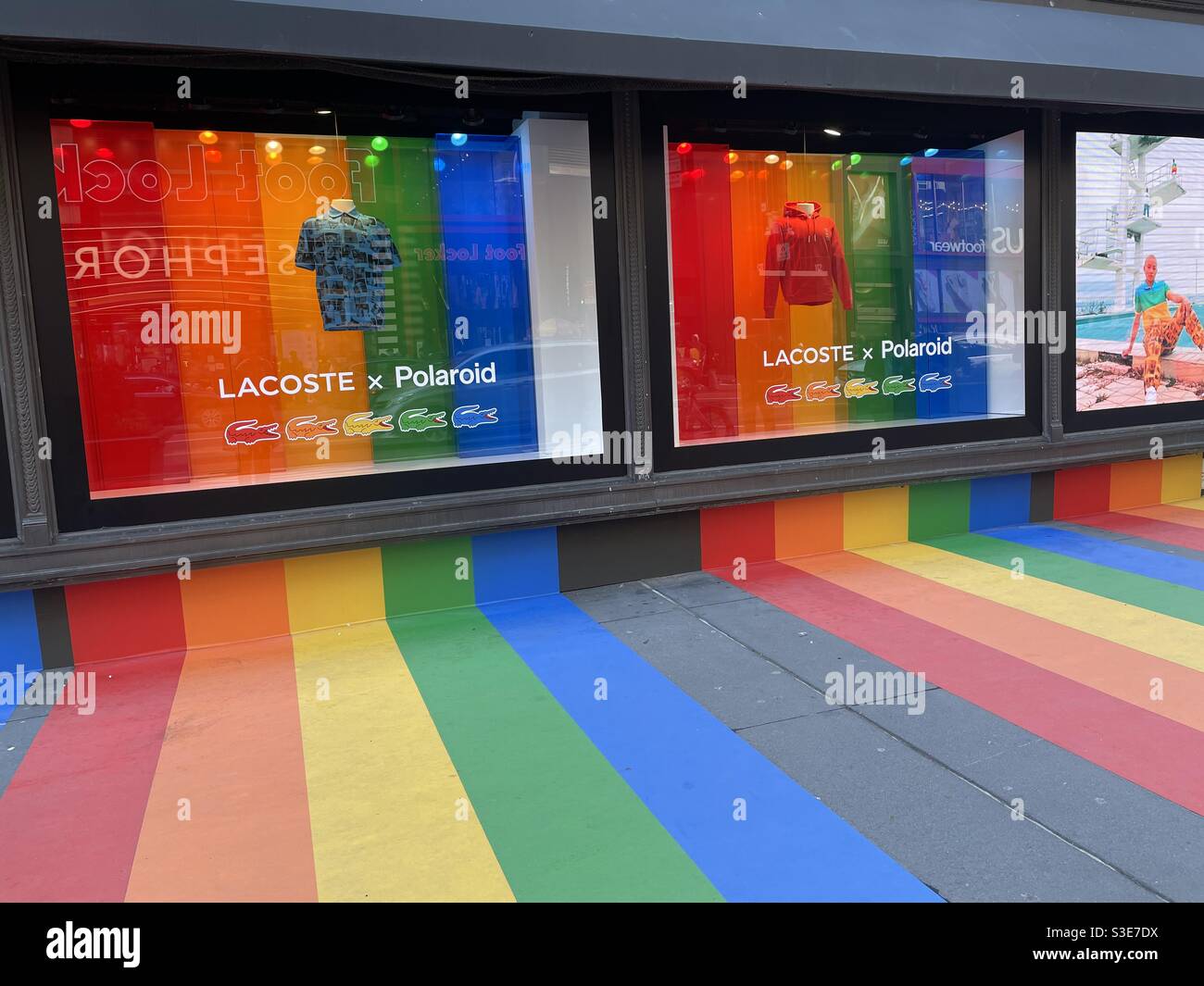 Rainbow colors Promoting LBGTQ pride on Macy’s windows and sidewalk in Herald Square, NYC, USA - Smartphone Captured Stock Image