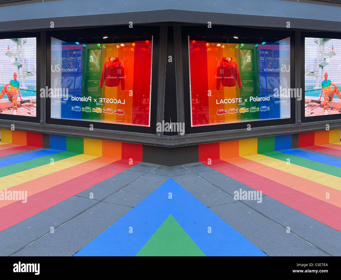 Rainbow colors promoting LBGTQ pride on Macy’s windows and sidewalk in Herald Square, NYC, USA - Smartphone Captured Stock Image
