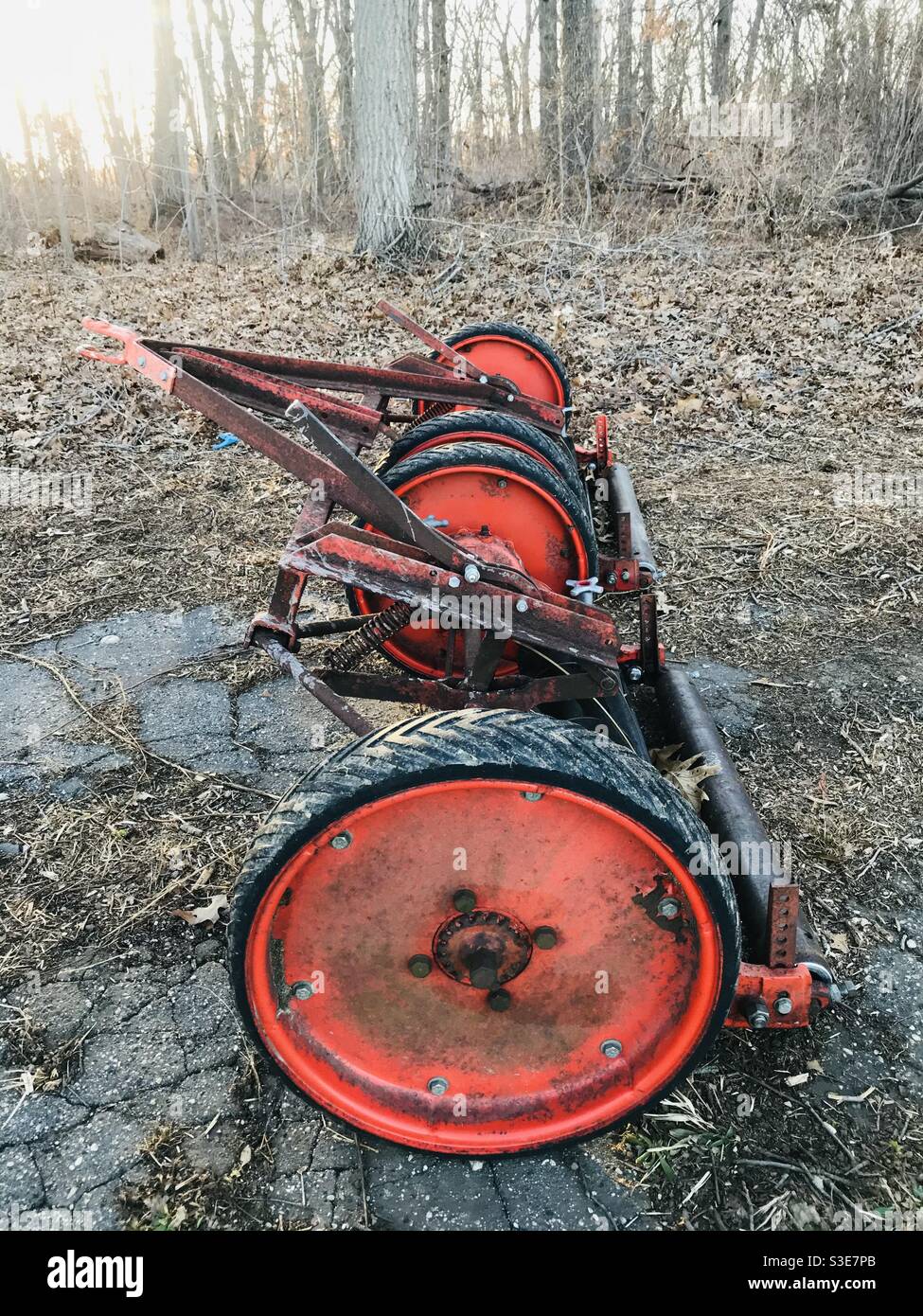 Red Grass Cutter in the Woods Stock Photo