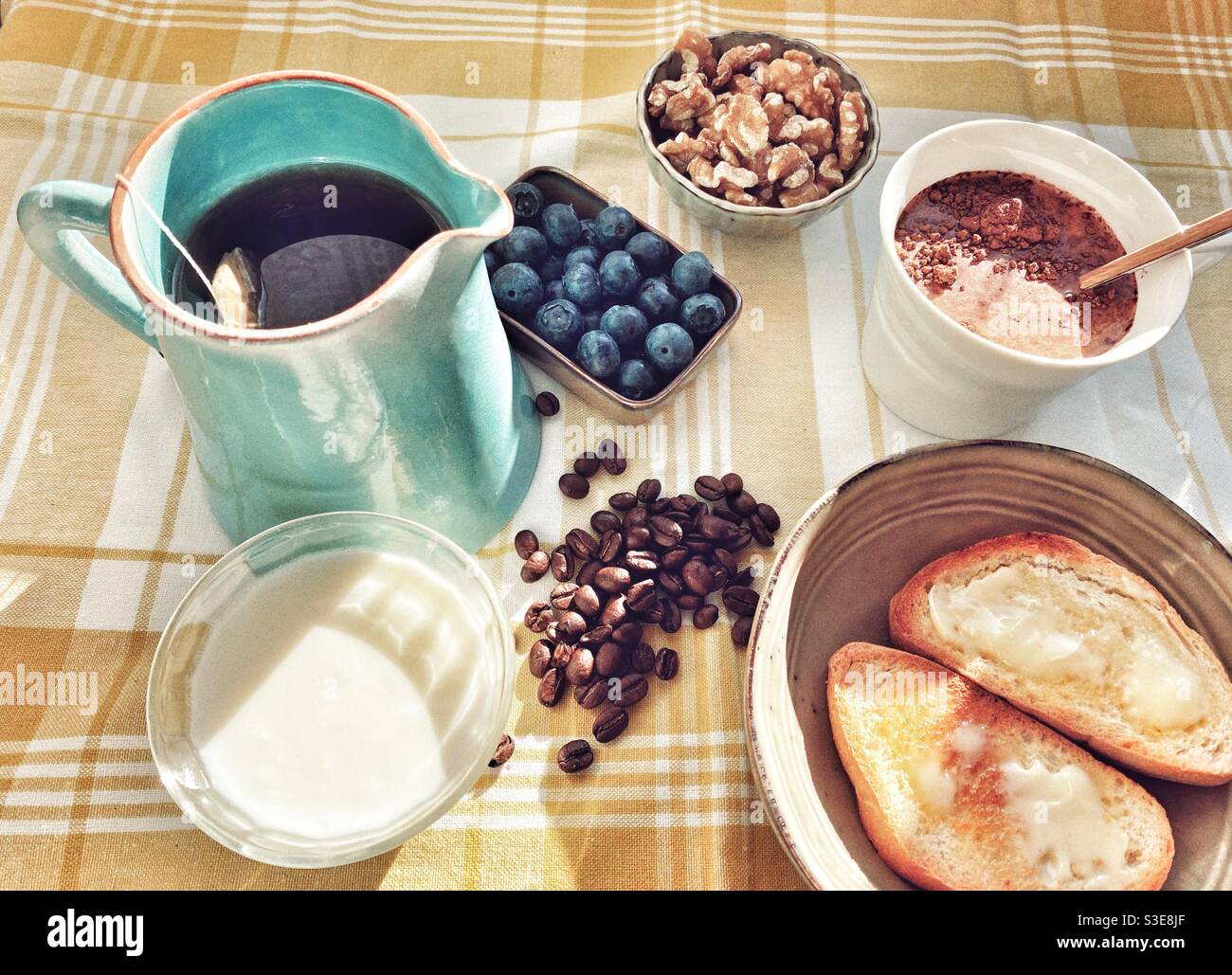 Relaxing breakfast with toast, tea, cranberries, walnuts and yummy stuff Stock Photo