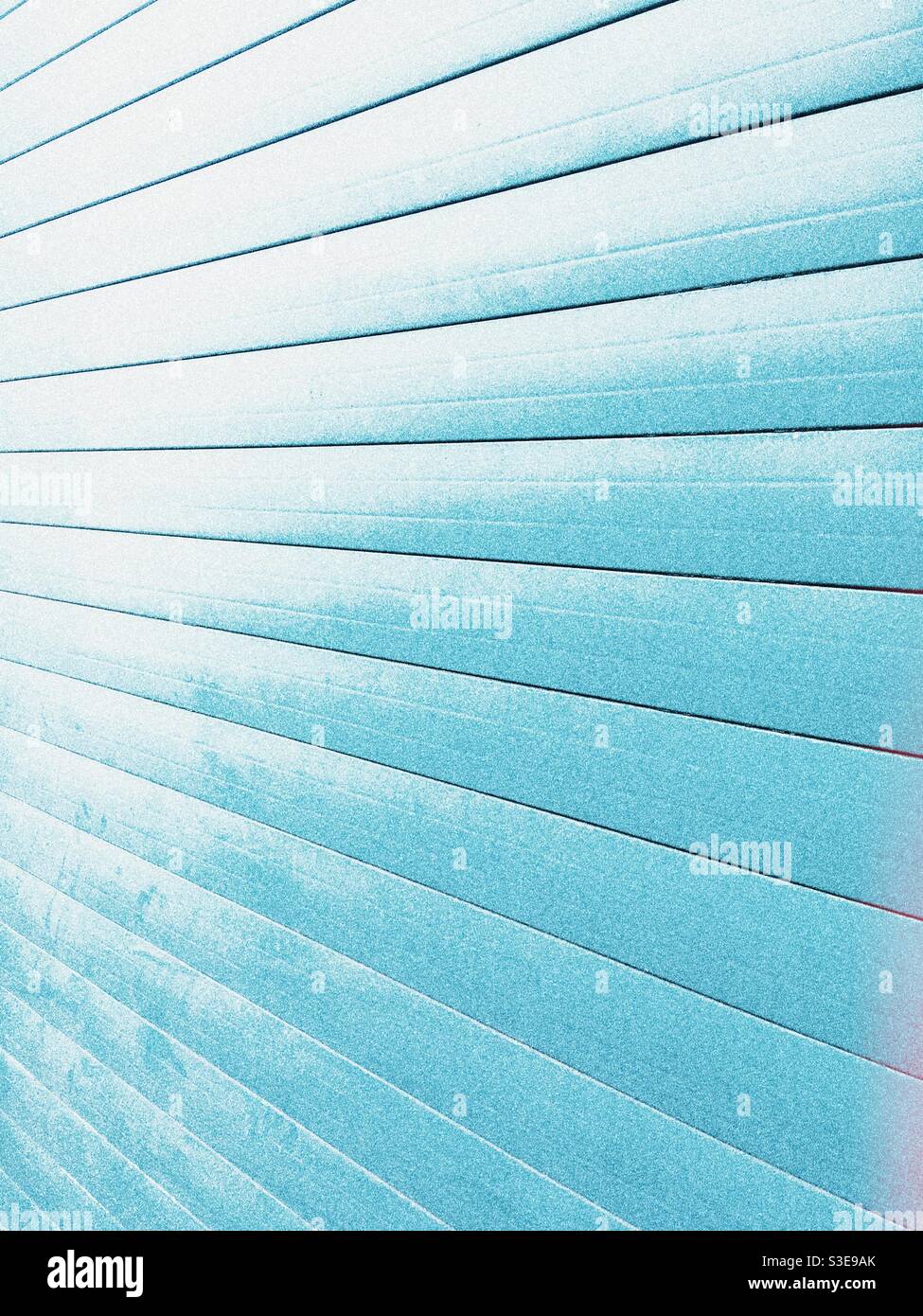 Perspective of light blue panels on a garage door. Abstract background image Stock Photo