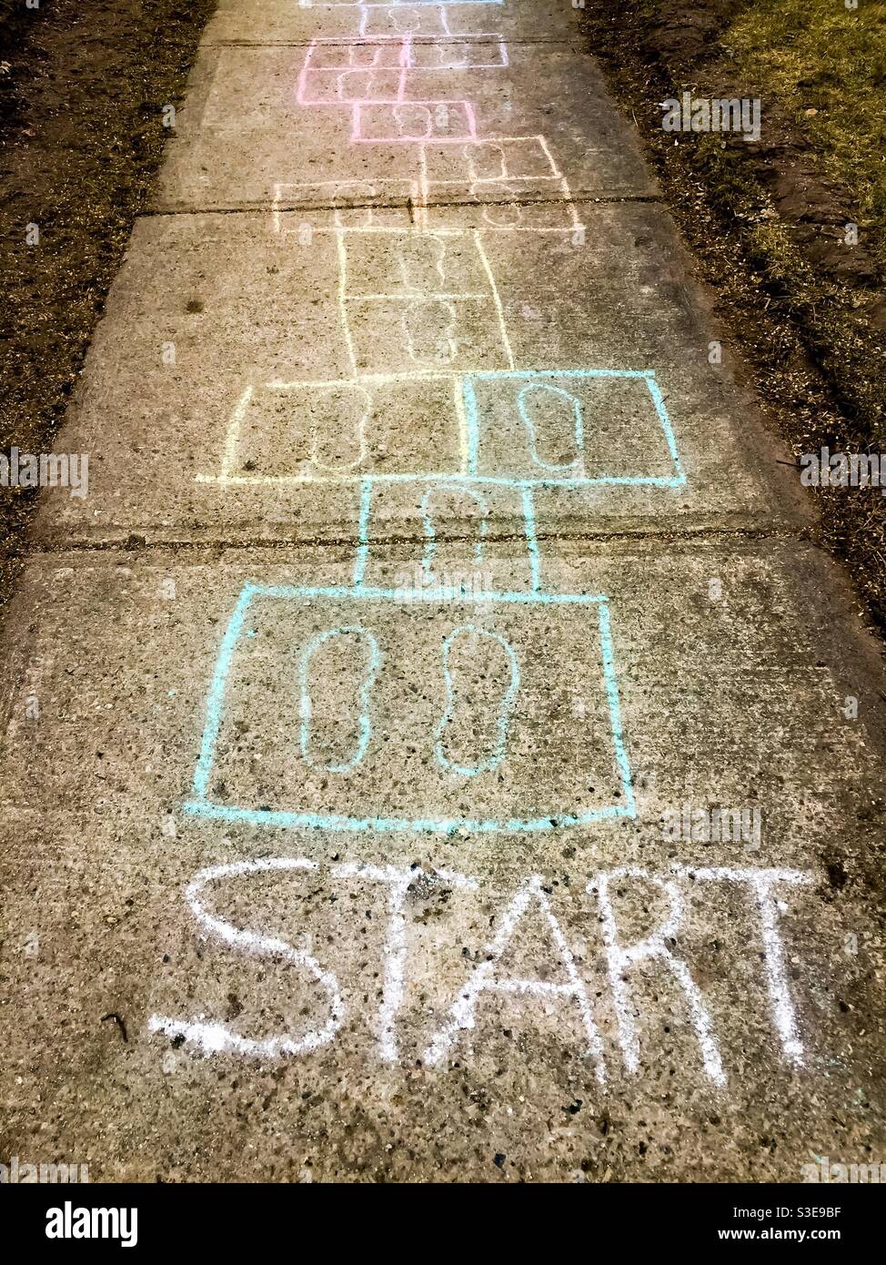 Hopscotch anyone? Squares and rectangles drawn in washable chalk on the pavement. Traditional layout used by children through the ages. Concepts: ephemera, temporary, Lowtech, age old. - Smartphone Captured Stock Image