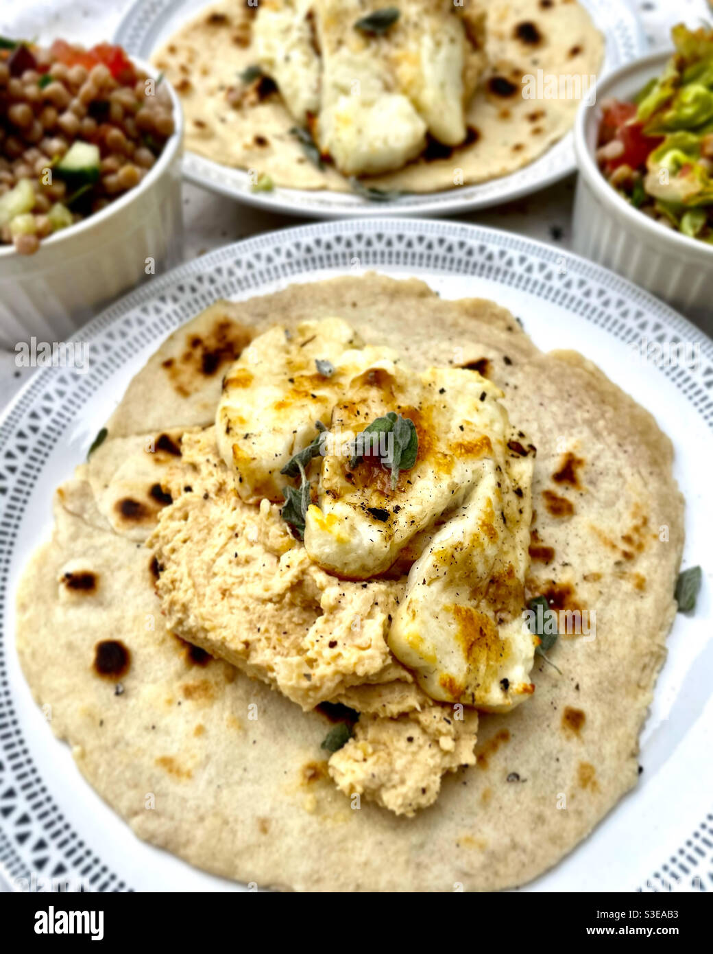 Halloumi and hummus on flatbread Stock Photo Alamy