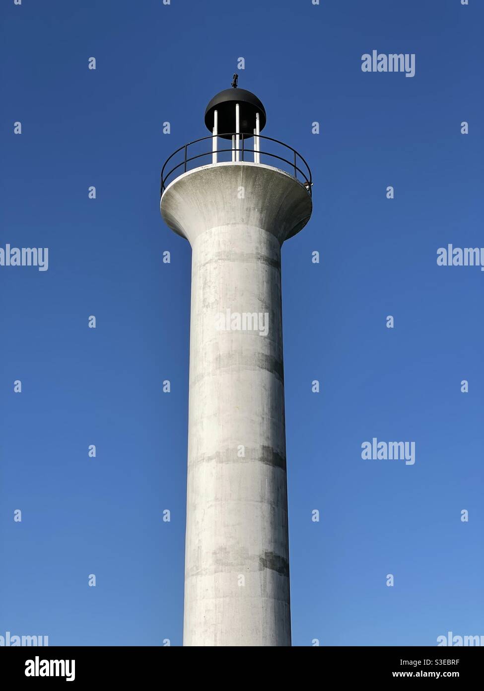Old Broadwater Marina lighthouse looking up Biloxi Mississippi with clear blue sky background - Smartphone Captured Stock Image