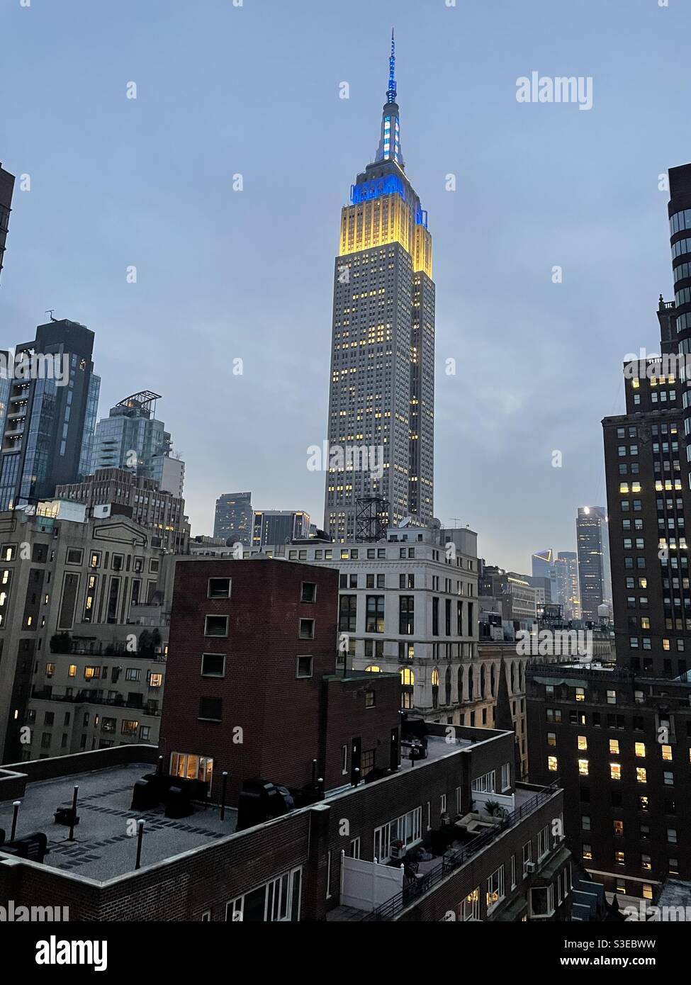 Empire State Building with blue and white lights - Smartphone Captured Stock Image