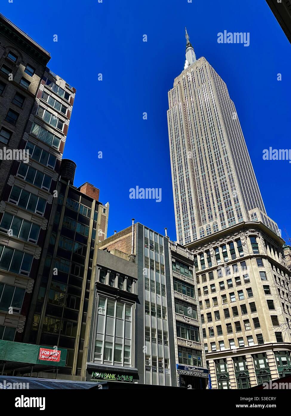 Looking upward at the Empire State building from Midtown South, NYC - Smartphone Captured Stock Image