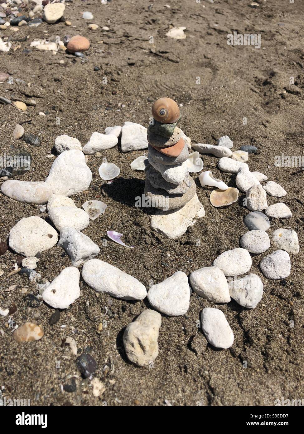 Balancing pebbles and seashell by the beach - Smartphone Captured Stock Image