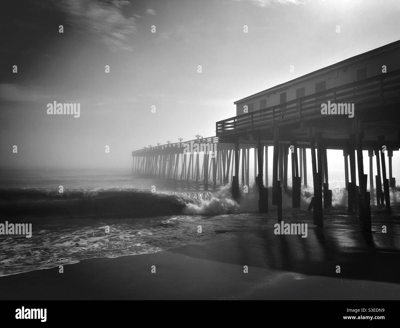 Ocean pier on a misty morning Stock Photo
