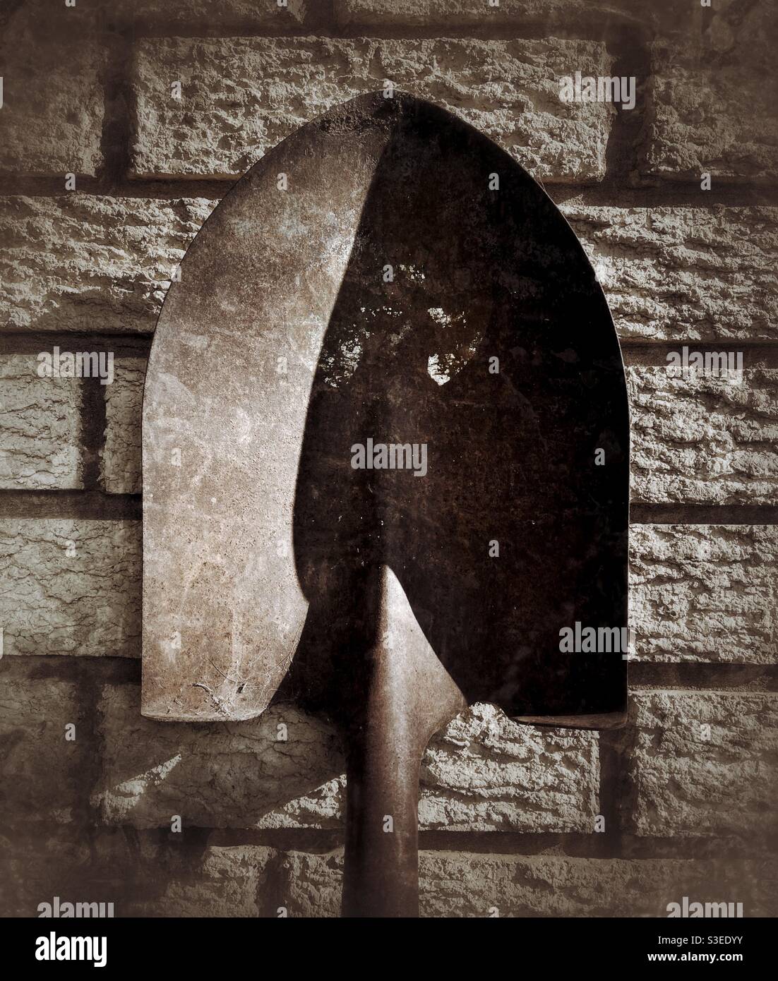 Shovel against a brick wall - Smartphone Captured Stock Image