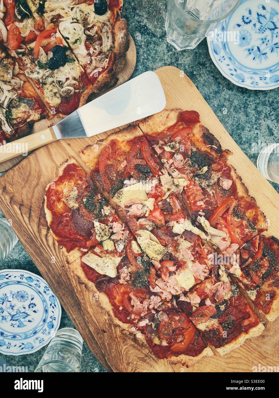 Homemade Pizza on a Wooden serving Board Stock Photo