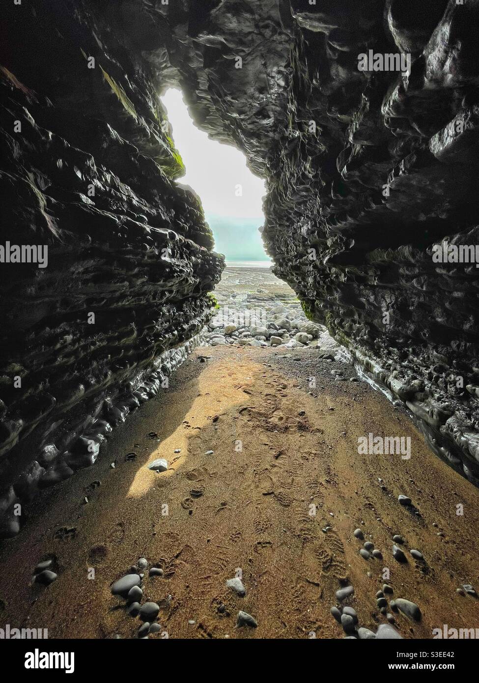View from inside a sea cave looking out, Southerndown, South Wales. - Smartphone Captured Stock Image