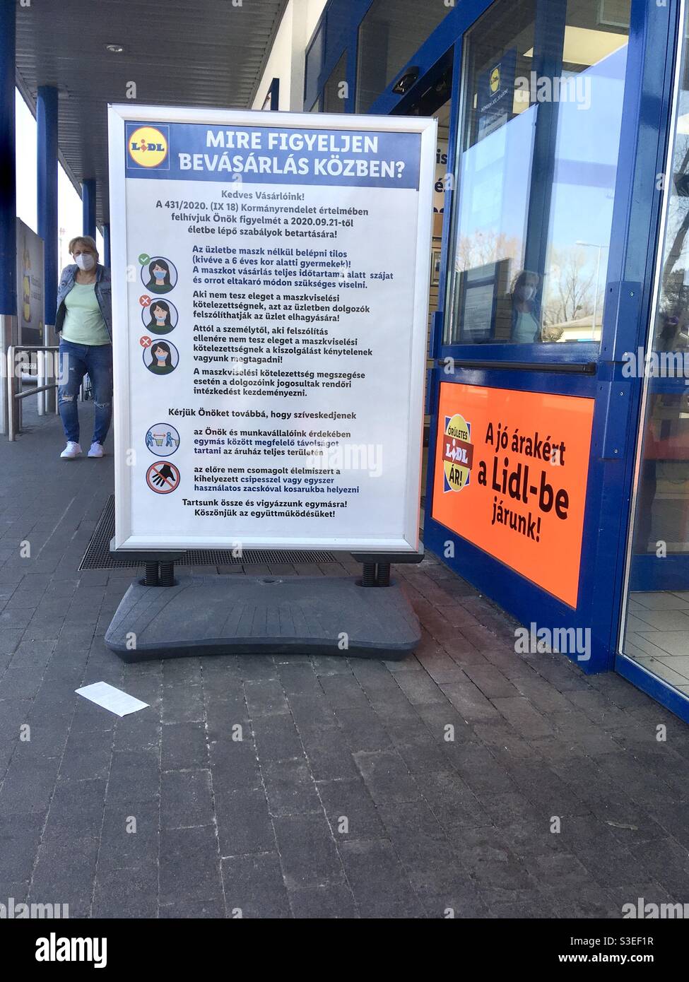 Board with instructions about COVID19 in front of LIDL supermarket, Sopron,Hungary Stock Photo