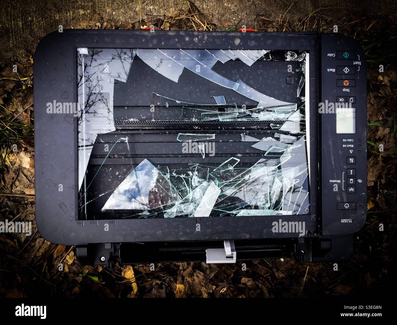 Broken technology, iconic image. Glass screen smashed on a printer, photocopier, fax machine