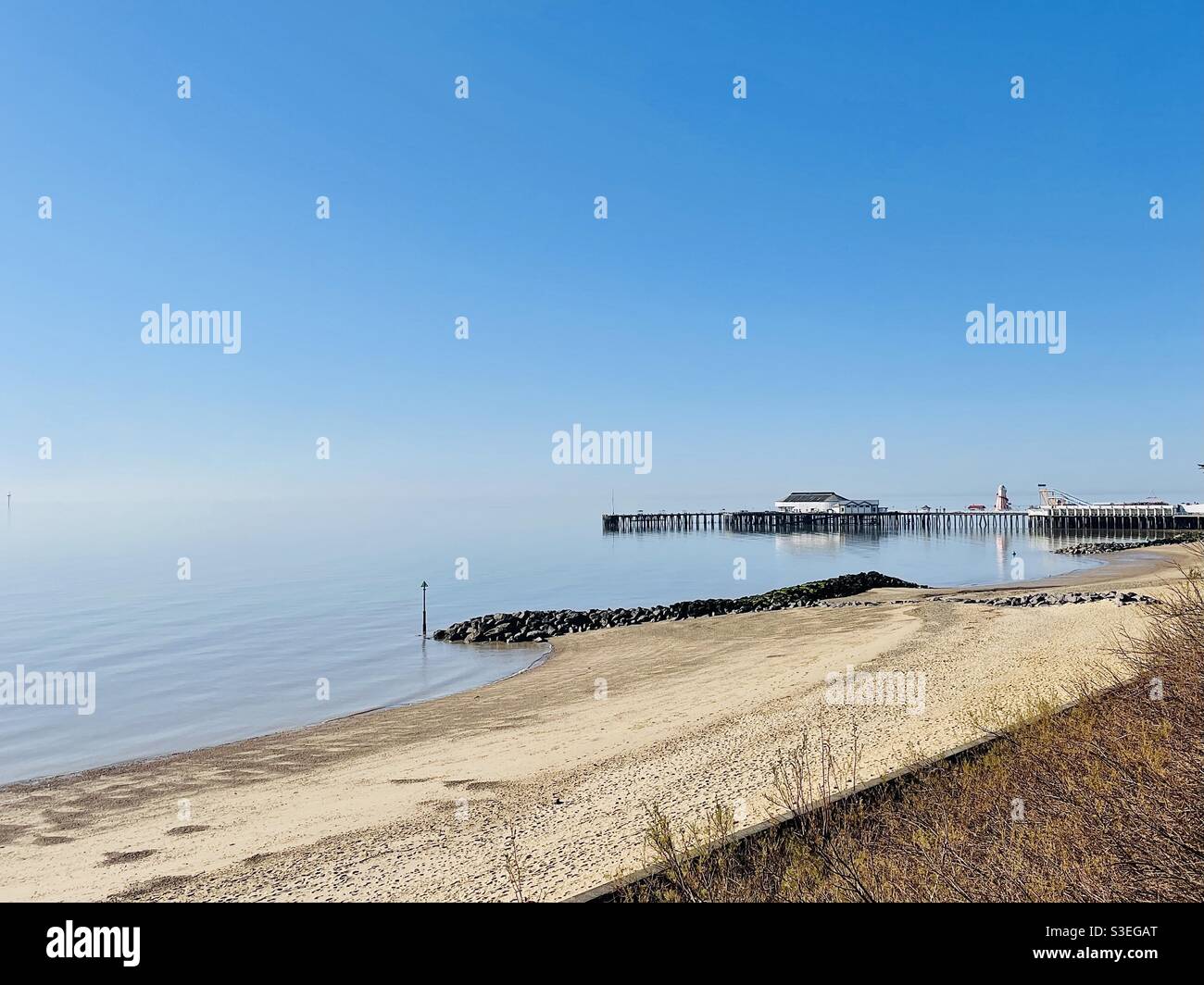 Deserted pier and beach at Clacton on Sea, Essex. A hot spring day during COVID-19 lockdown - Smartphone Captured Stock Image