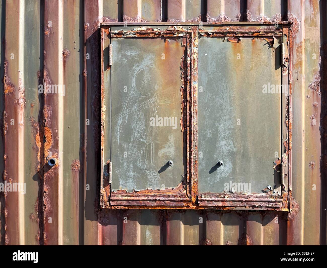 Rusty window shutter on an old shipping container Stock Photo