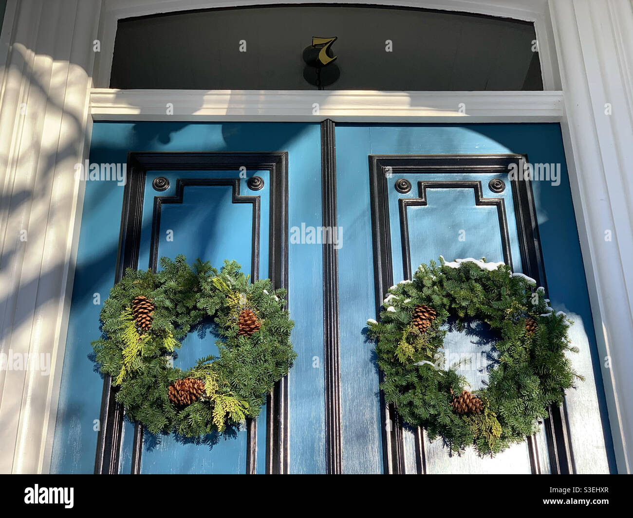 December, 2020, wreaths on the front doors of a house near downtown Salem, Massachusetts, United States - Smartphone Captured Stock Image