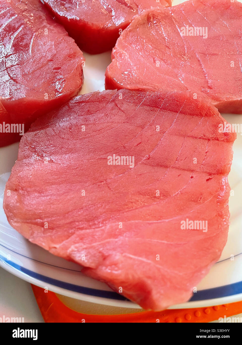 Close up of a platter filled with raw sushi grade tuna steaks - Smartphone Captured Stock Image