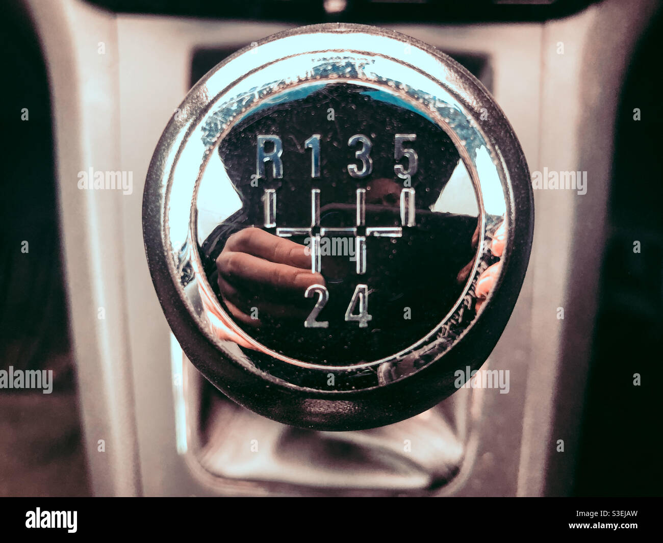 Top of a gear stick in a manual transmission car. - Smartphone Captured Stock Image