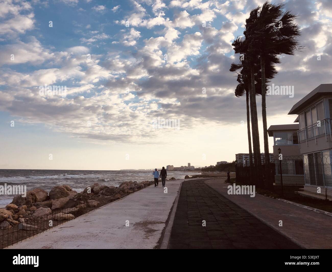 People walking by the sea Stock Photo