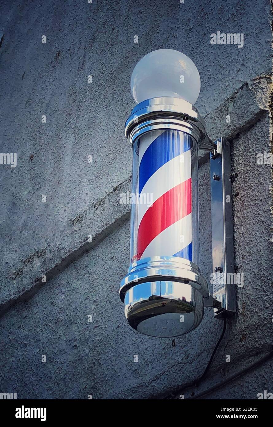A Barbershop pole outside a Barber or hairdresser shop - Smartphone Captured Stock Image
