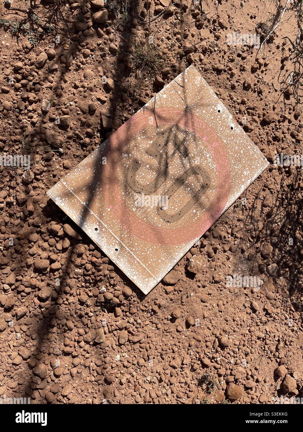 An old speed limit sign lies in the red dirt near Lightning Ridge, New South Wales, Australia - Smartphone Captured Stock Image