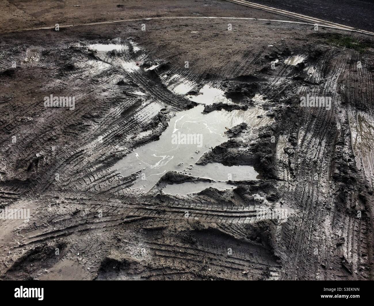 Muddy puddle rutted with tyre tracks - Smartphone Captured Stock Image