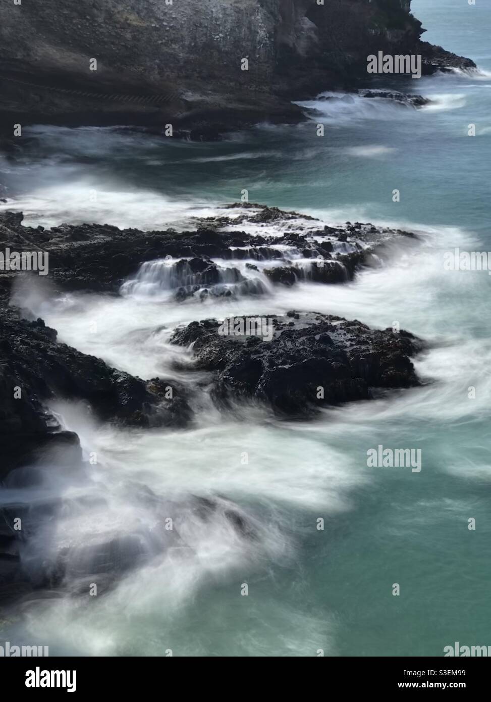 Long exposure of ocean waves breaking over rocks on New Zealand’s South Island - Smartphone Captured Stock Image