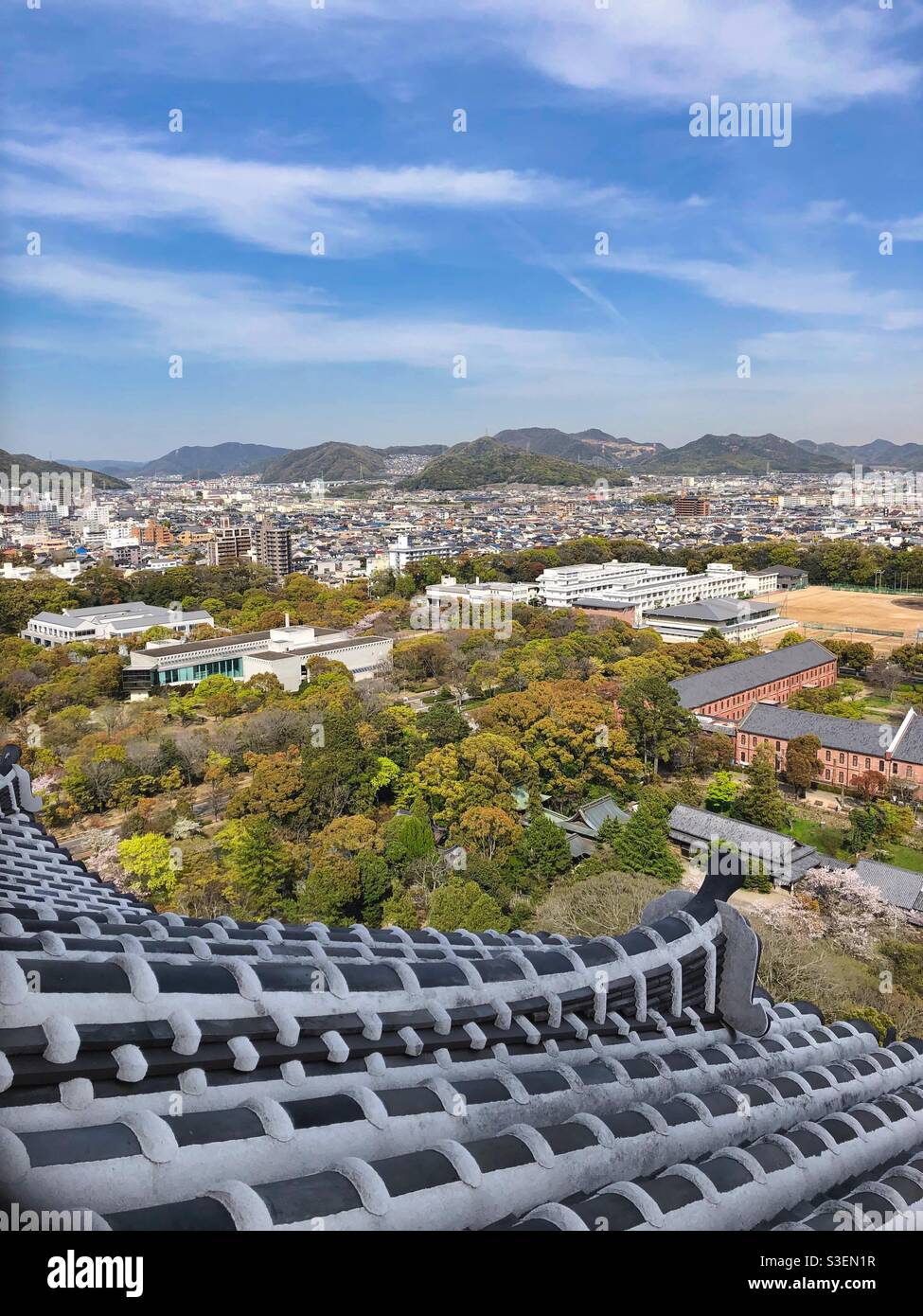 Spring view from Himeji Castle at Himeji town and green mountains, Japan. - Smartphone Captured Stock Image