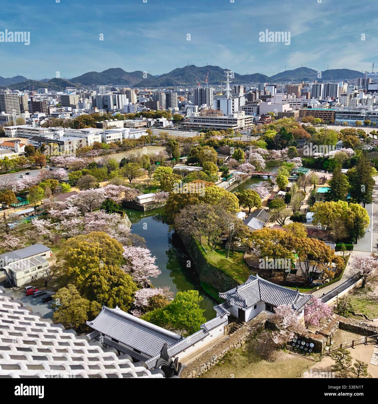 View from Himeji Castle at Himeji town with gardens and mountains in the background, Japan. - Smartphone Captured Stock Image