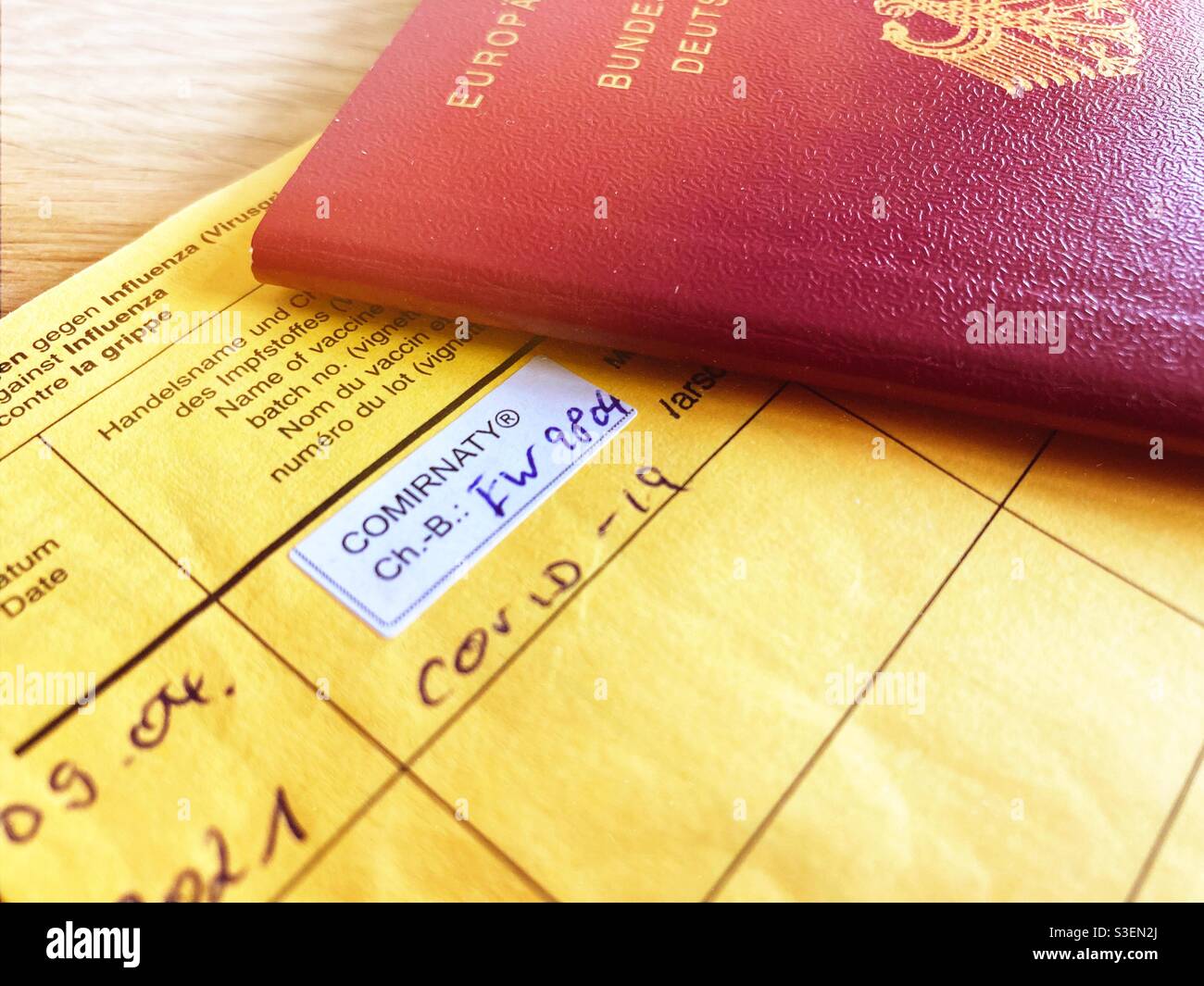 An international certification of vaccination with the entry of the First Biontech Comirnaty vaccination and a German passport - Smartphone Captured Stock Image