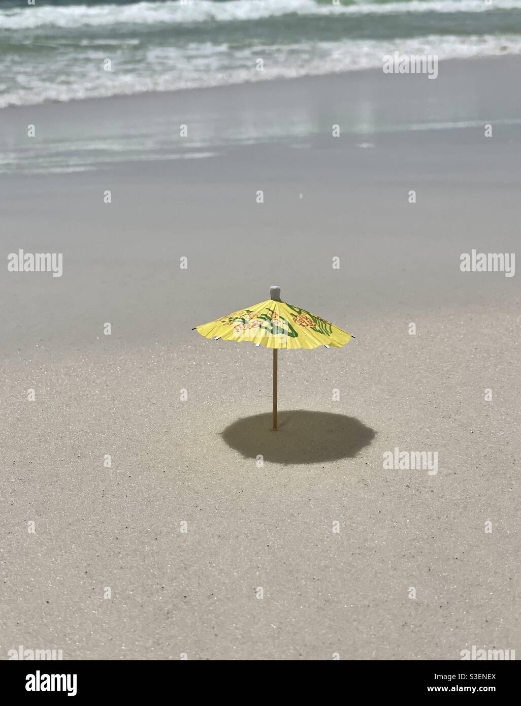 Miniature beach umbrella with shadow on beach sand Stock Photo Alamy