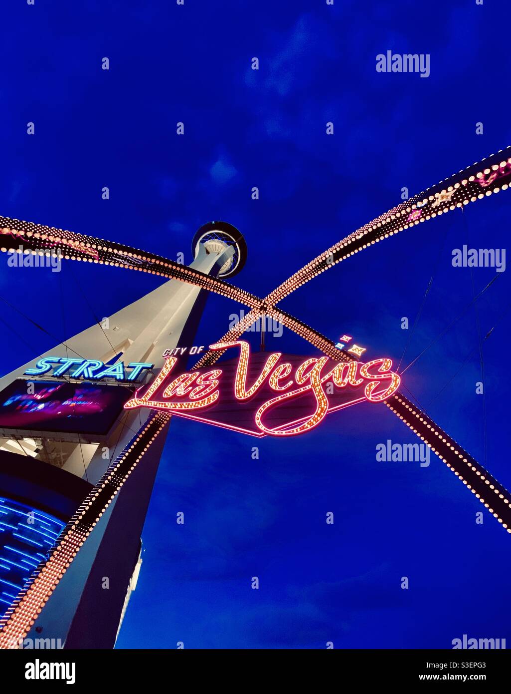Welcome to Las Vegas sign that straddles Las Vegas boulevard, with iconic Stratosphere Casino tower. - Smartphone Captured Stock Image