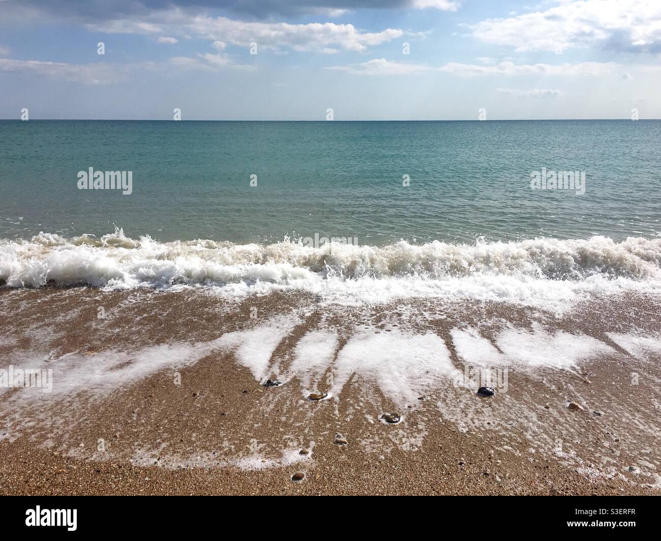 Waves breaking on pebbly beach - Smartphone Captured Stock Image