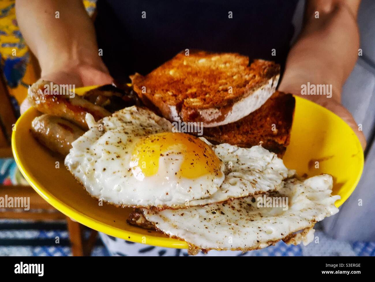 Fried eggs with sausage and toast. - Smartphone Captured Stock Image