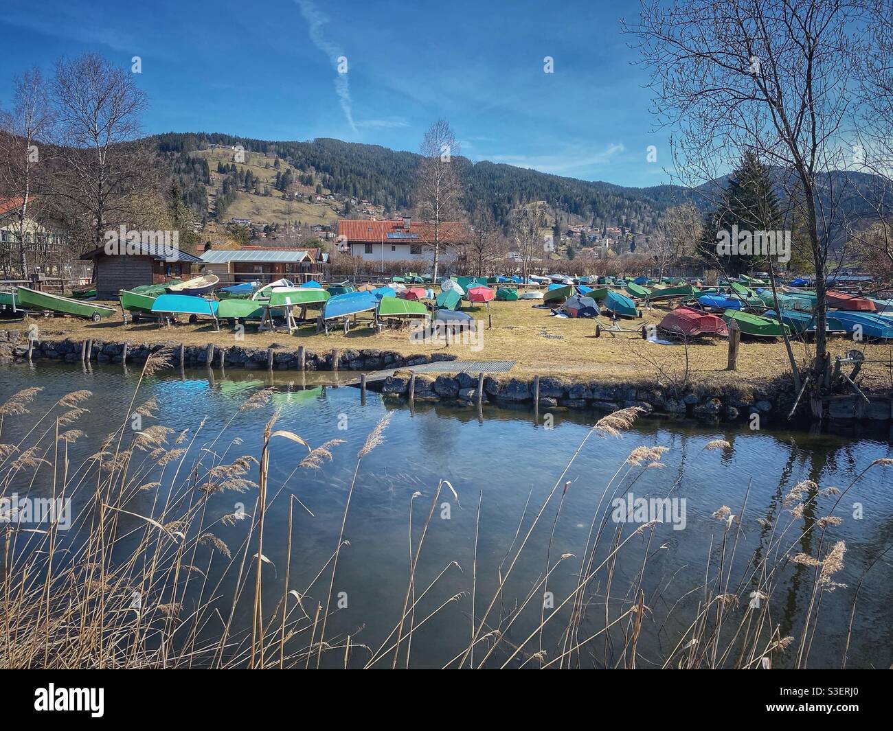 Colorful boats at lake Schliersee and its Schlierach spring in Bavarian Alps, Germany. - Smartphone Captured Stock Image Colorful boats at lake Schliersee and its Schlierach spring in Bavarian Alps, Germany. - Smartphone Captured Stock Image