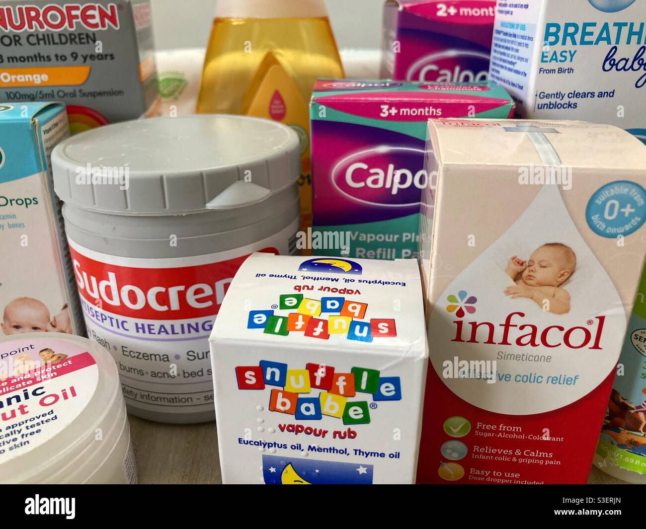A selection of baby medicine/ drugs/ care products including the well know brands of Calpol, Sudocreme, Infracol, Snuffle babe, breath easy baby, Nurofen and Johnson hair shampoo Stock Photo