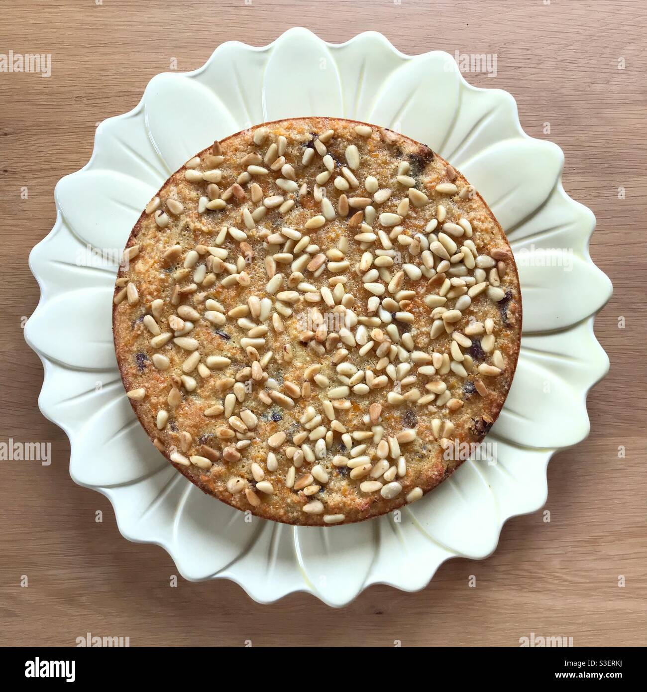 Carrot cake with pine nuts on a daisy plate - Smartphone Captured Stock Image