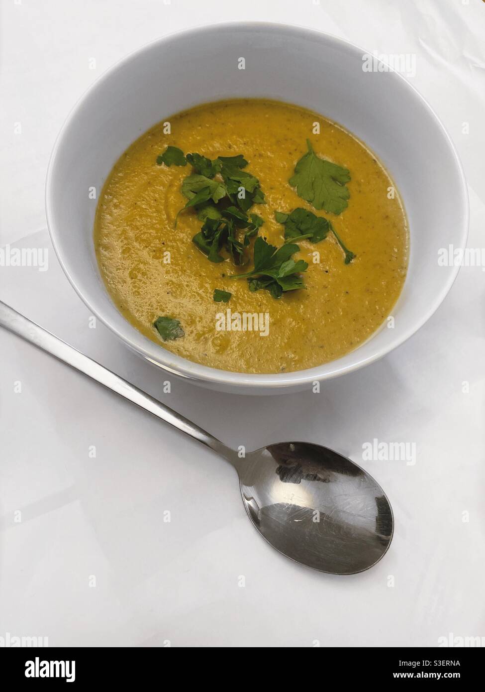 Spiced curry cauliflower soup and silver spoon Stock Photo