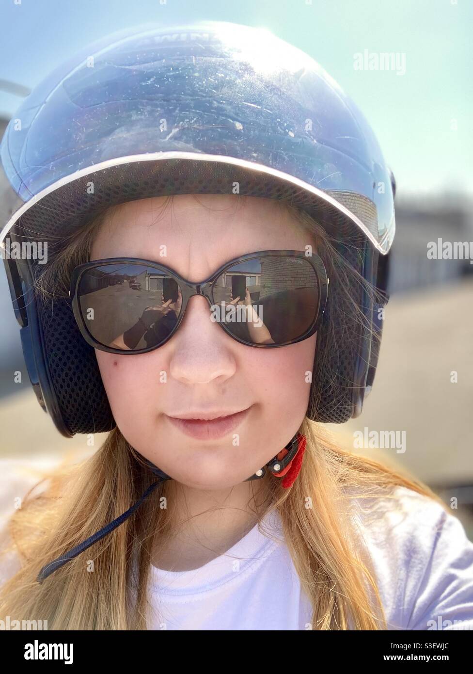 A woman in motorcycle helmet and sunglasses Stock Photo Alamy