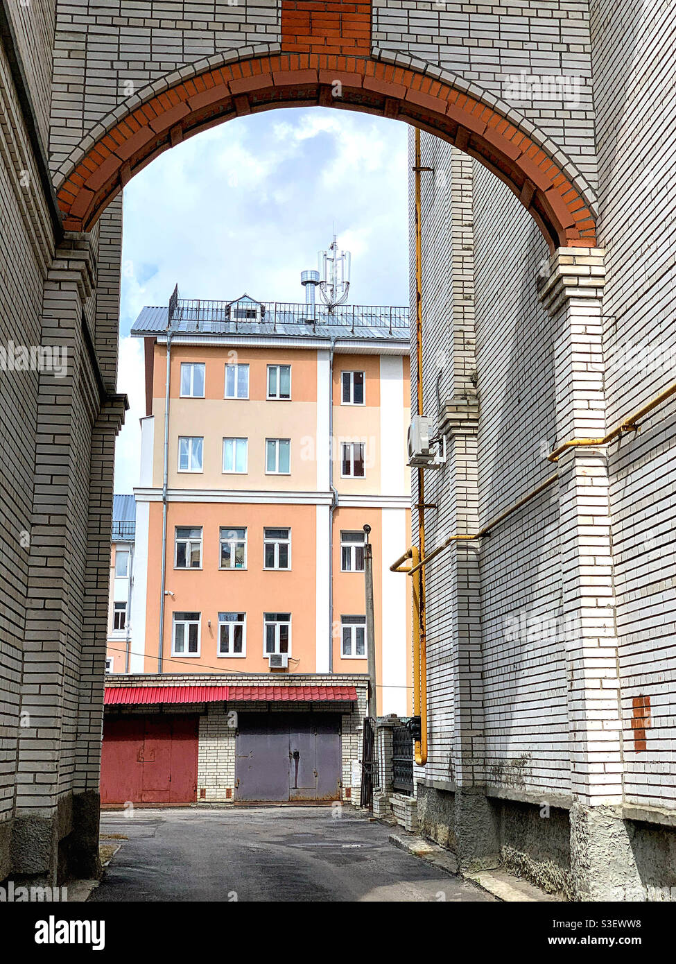 View of the cityscape through a brick arch - Smartphone Captured Stock Image